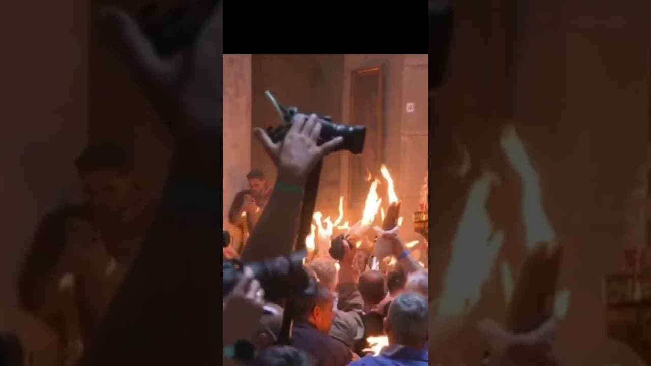 The climax of the Holy Fire ceremony at the Church of the Holy Sepulchre (Resurrection), Jerusalem.